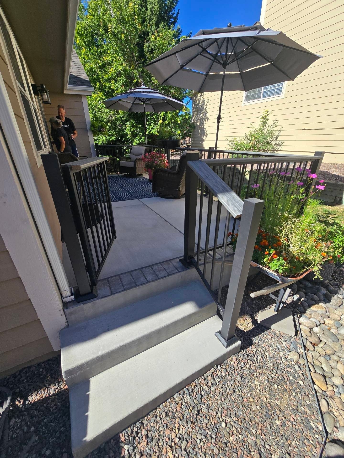 Patio with Umbrellas and Flower Beds — Yardage Outdoor Living